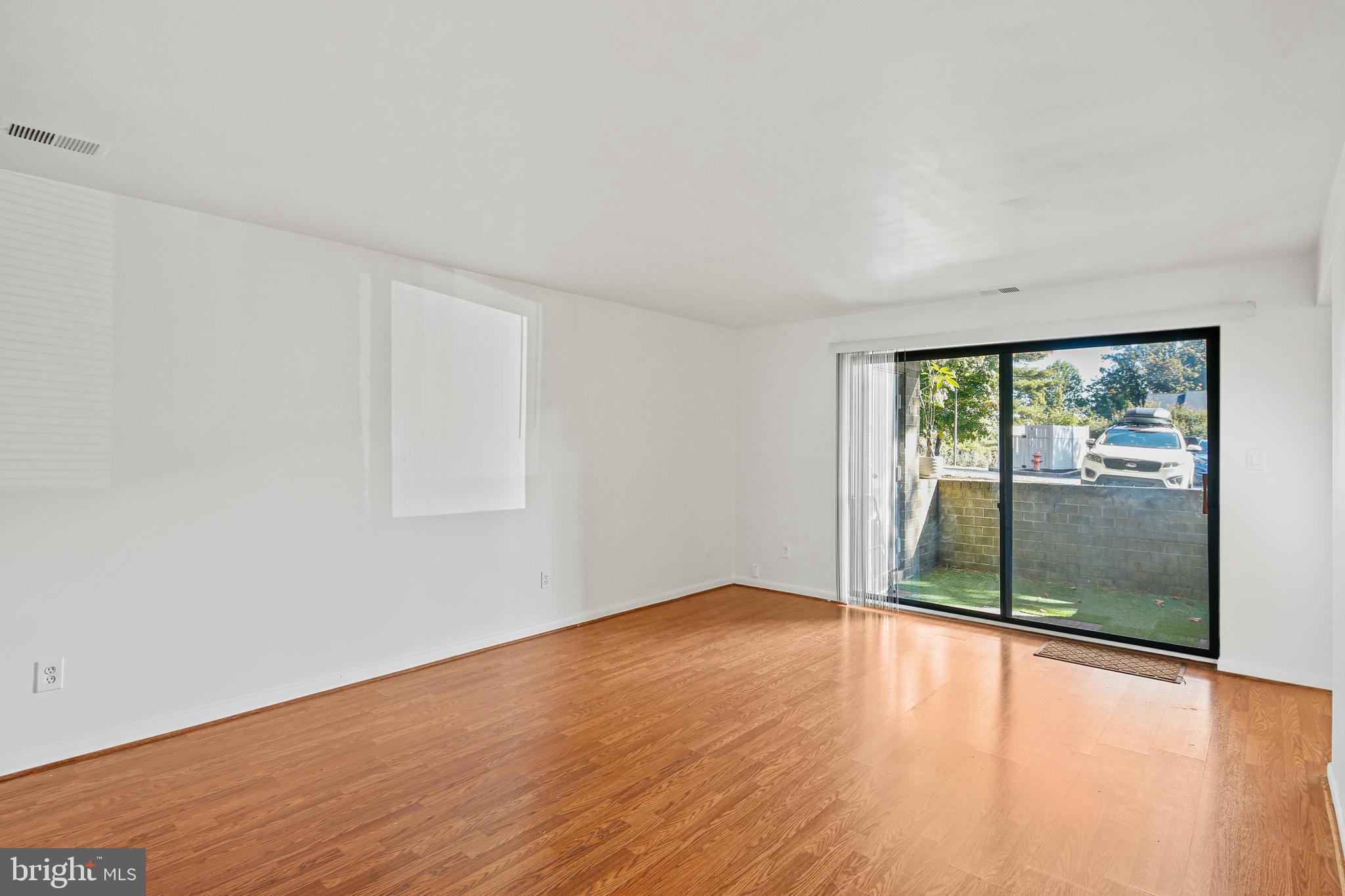 2 Bailiffs Court, Unit 102 Lutherville-Timonium, MD 21093 - Photo 16 of 34 wooden floor in an empty room with a window