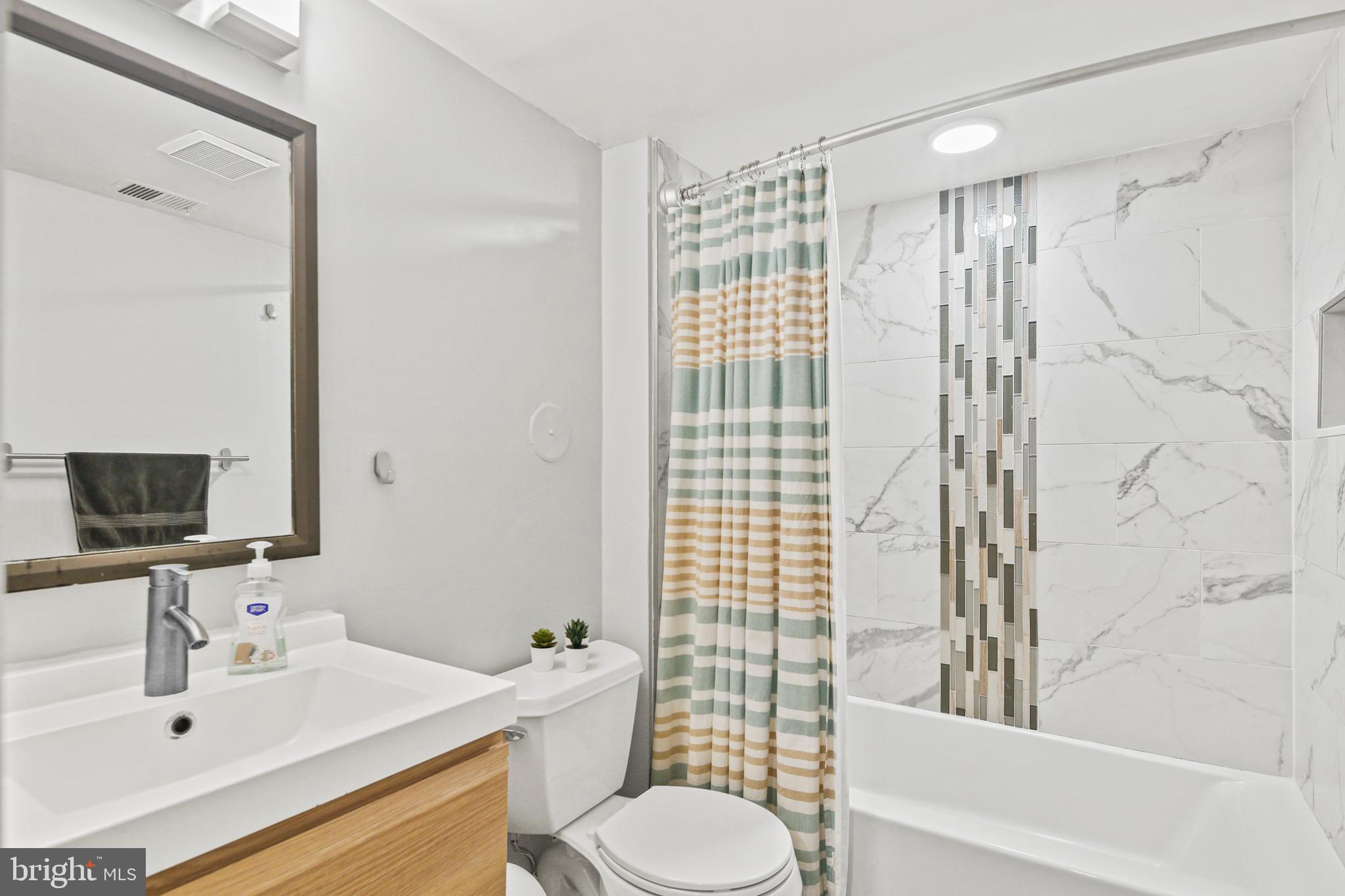 2 Bailiffs Court, Unit 102 Lutherville-Timonium, MD 21093 - Photo 18 of 34 a bathroom with a sink toilet tub and shower