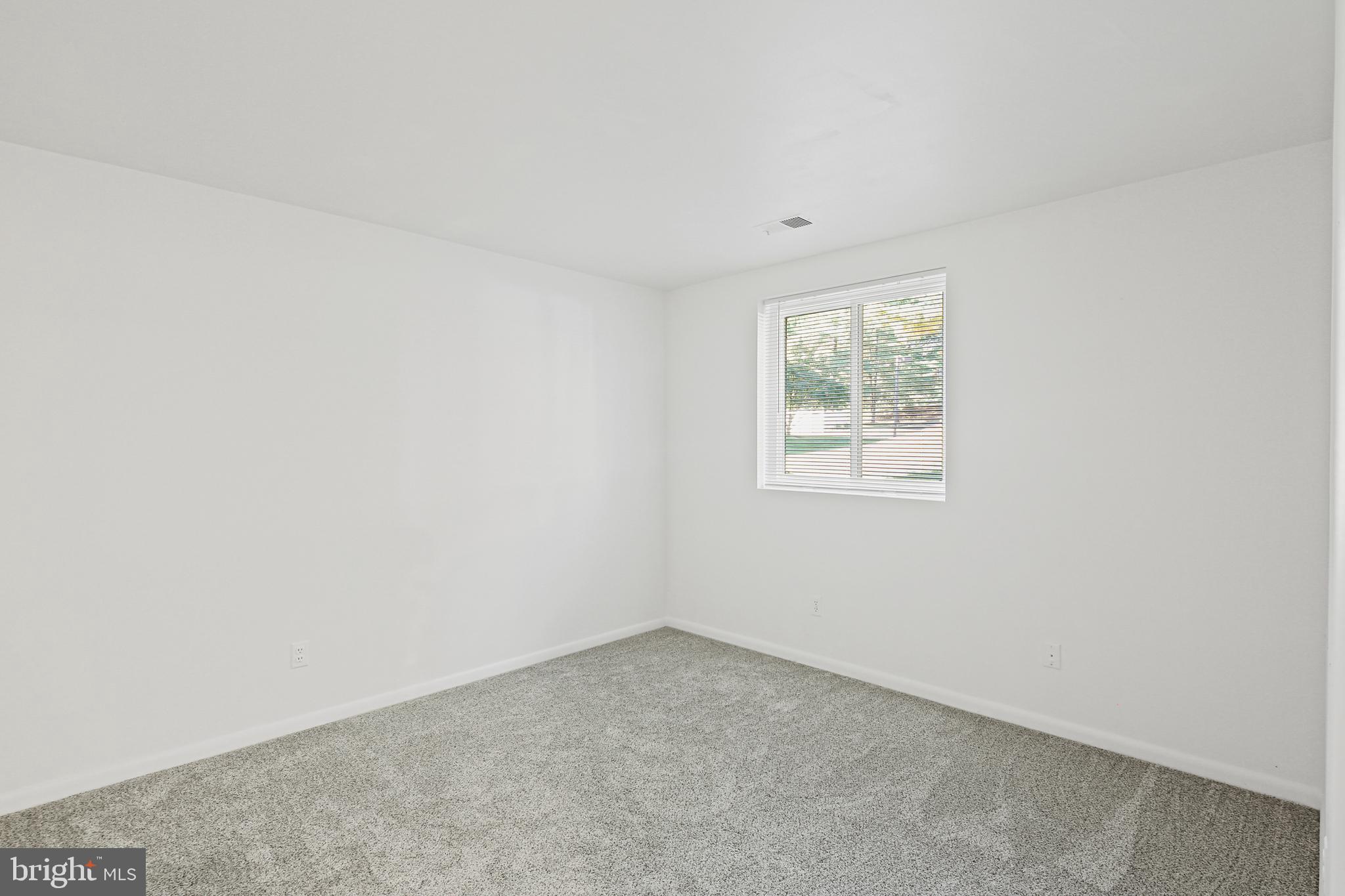 2 Bailiffs Court, Unit 102 Lutherville-Timonium, MD 21093 - Photo 20 of 34 an empty room with windows