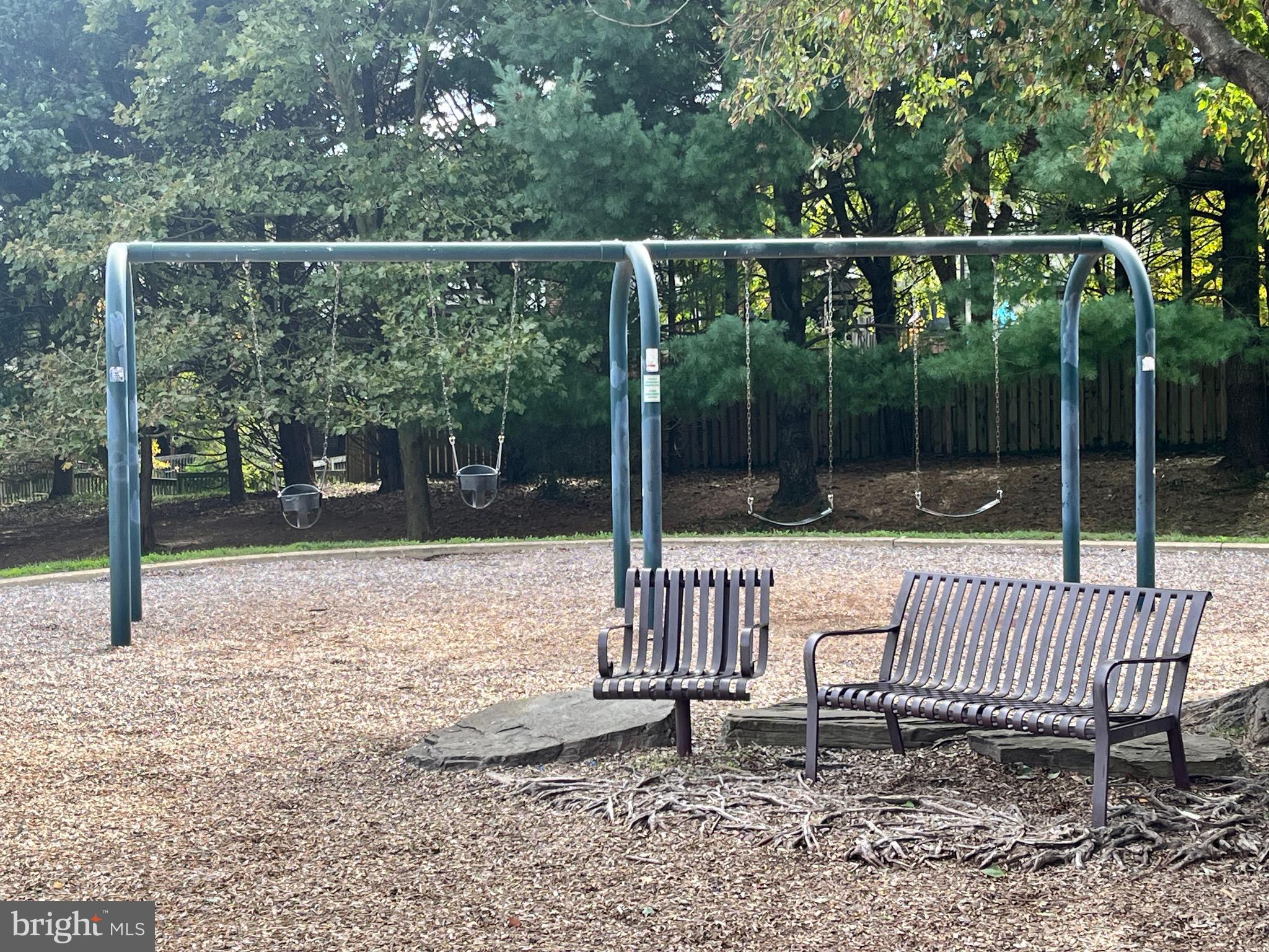2 Bailiffs Court, Unit 102 Lutherville-Timonium, MD 21093 - Photo 30 of 34 a view of a deck with a bench and wooden fence