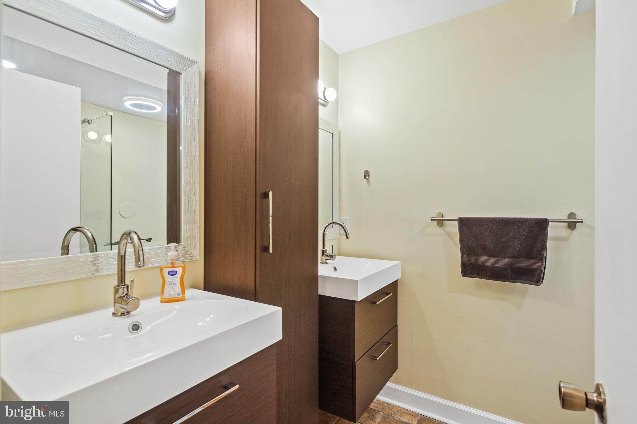 2 Bailiffs Court, Unit 102 Lutherville-Timonium, MD 21093 - Photo 10 of 34 a bathroom with a sink and a mirror
