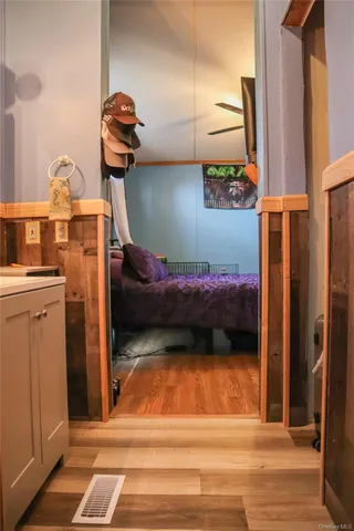 a bedroom with a bed and a mirror