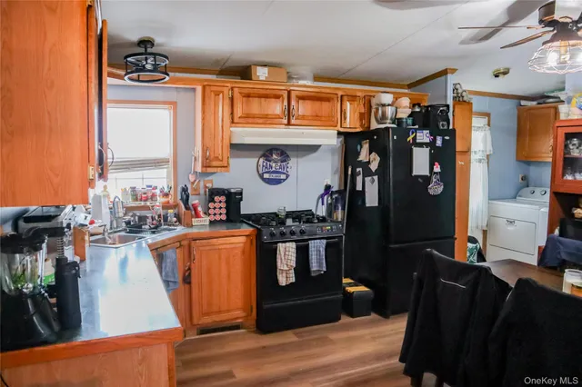a kitchen with stainless steel appliances granite countertop a refrigerator and a stove