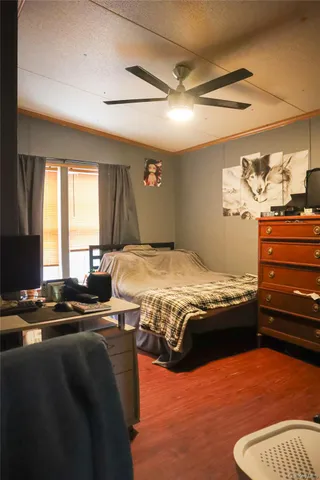 a bedroom with a bed and dresser with mirror