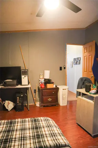 a bedroom with furniture and a wooden floor