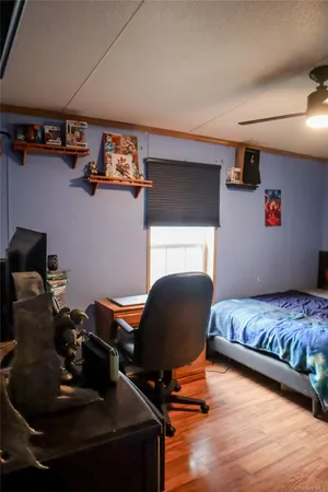 a bedroom with furniture and a chair