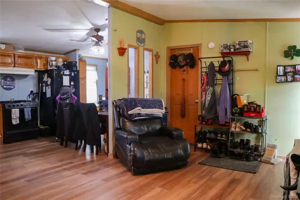 a view of a workspace with furniture and wooden floor
