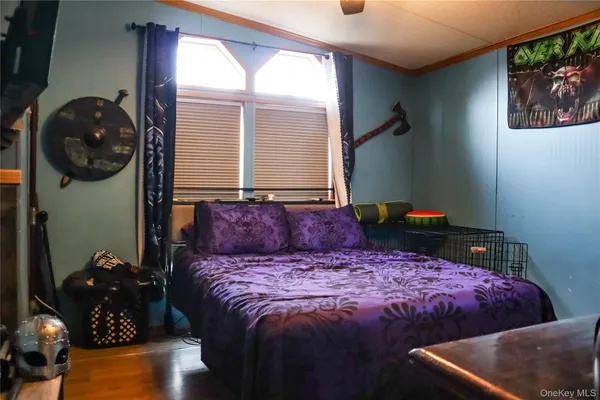 a bed sitting in a bedroom next to a window