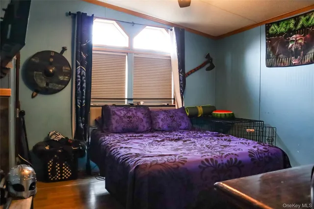 a bed sitting in a bedroom next to a window