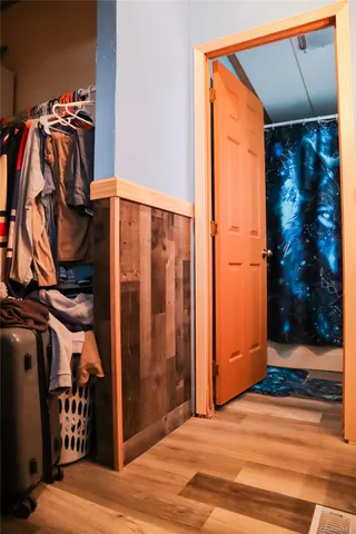 a view of walk in closet with clothes and shoes