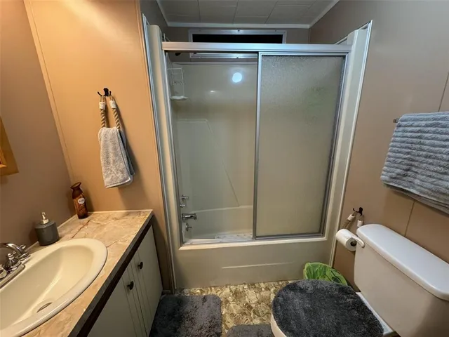 a bedroom with a bed a mirror and furniture