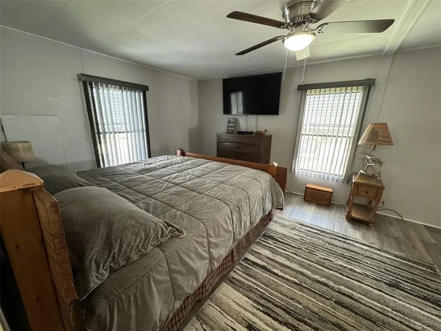 a bedroom with a bed lamp and a chandelier