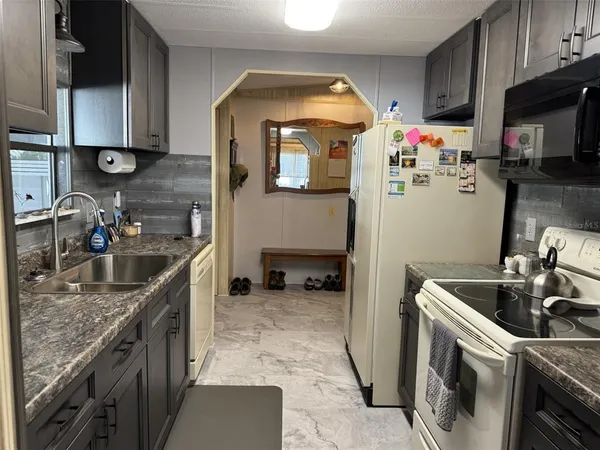 a kitchen that has a sink and a stove