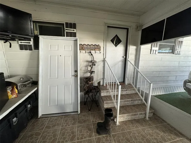 a front view of a house with a garden and trees
