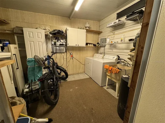 a backyard of a house with barbeque oven table and chairs