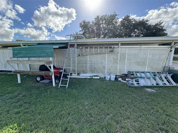 a view of a garden with a bench under an umbrella