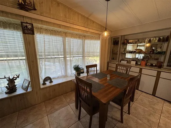 a dining room with furniture and window