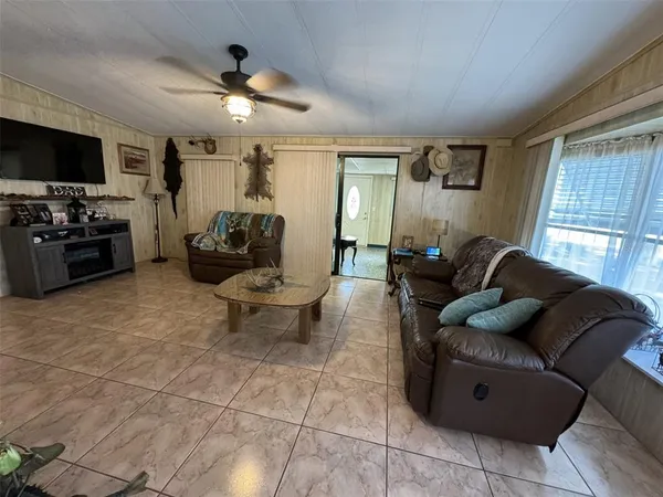 a living room with furniture and a flat screen tv