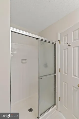 a bathroom with a glass shower door