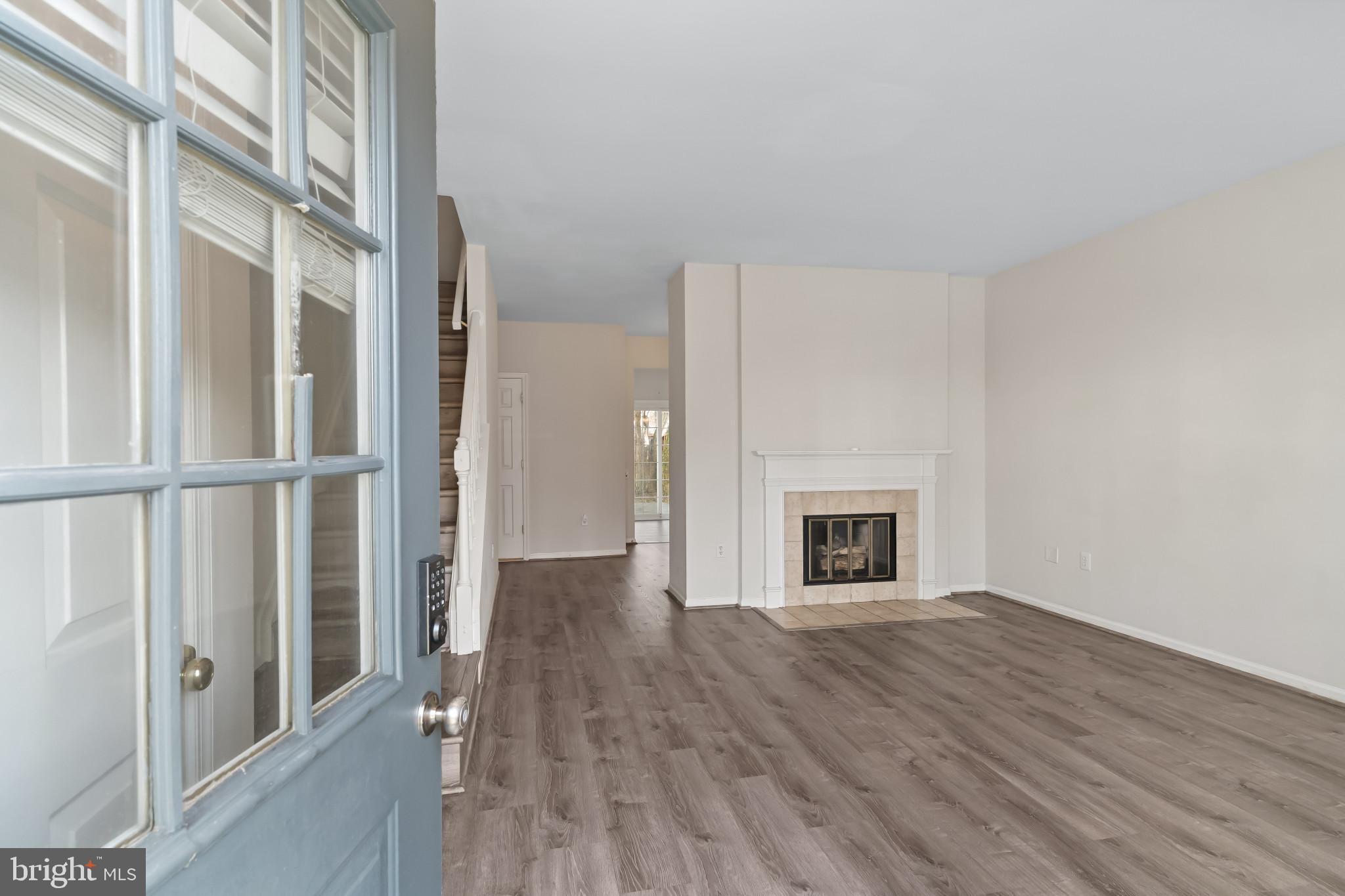 7115 Strawn Court Alexandria, VA 22306 - Photo 4 of 27 a view of a livingroom with wooden floor and a fireplace