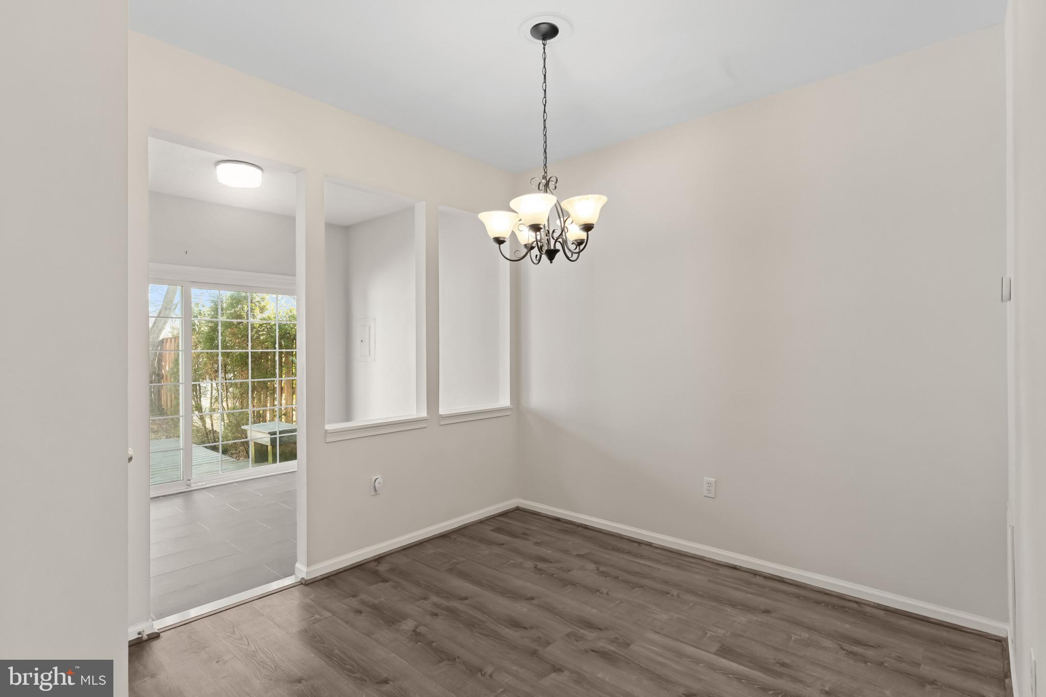 7115 Strawn Court Alexandria, VA 22306 - Photo 8 of 27 a view of a chandelier in big room and chandelier