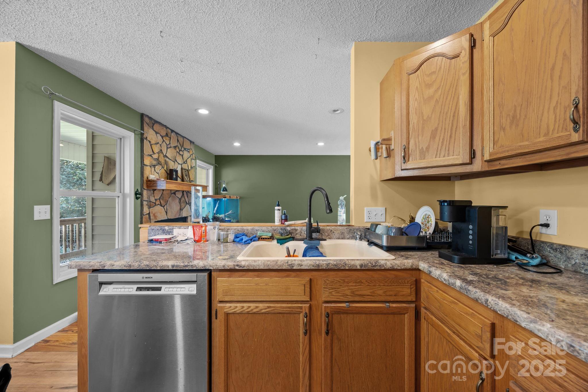 55 Pine Bluff Road Hendersonville, NC 28792 - Photo 11 of 47 a kitchen with stainless steel appliances granite countertop a sink stove and cabinets