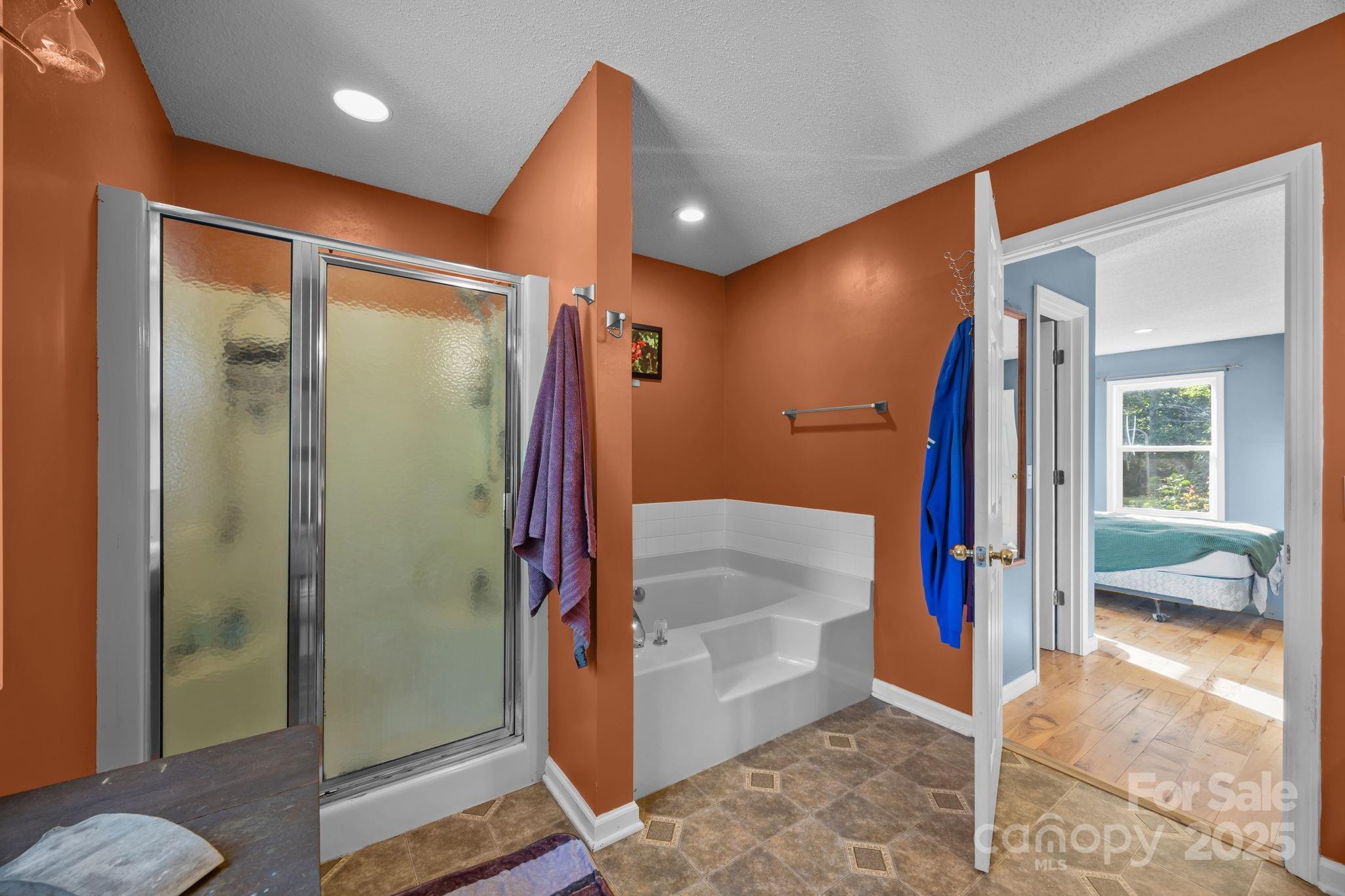 55 Pine Bluff Road Hendersonville, NC 28792 - Photo 18 of 47 a bathroom with a tub and shower