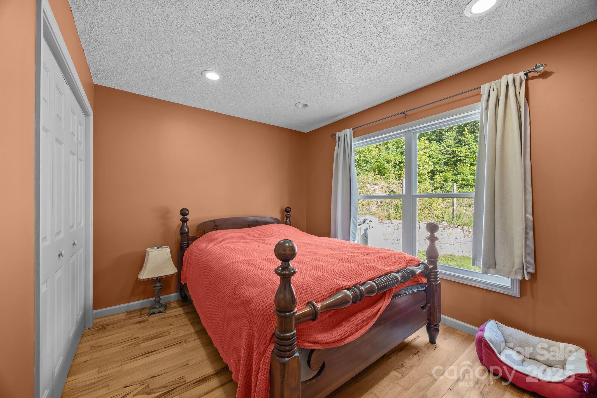 55 Pine Bluff Road Hendersonville, NC 28792 - Photo 21 of 47 a bed sitting in a bedroom next to a window