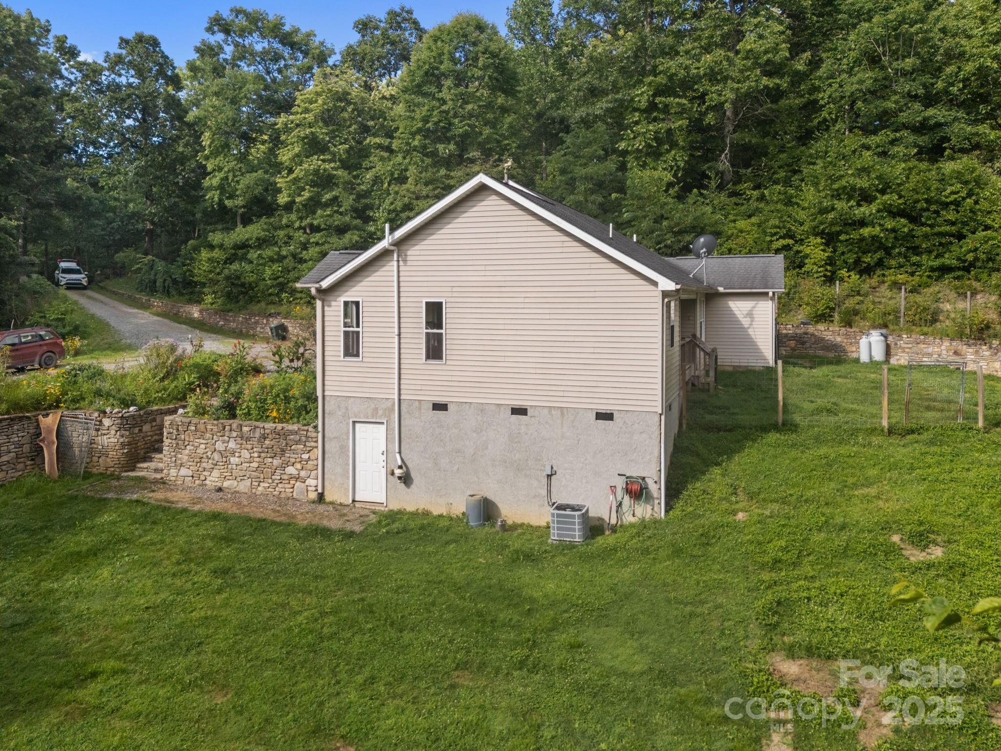 55 Pine Bluff Road Hendersonville, NC 28792 - Photo 32 of 47 a view of a house with backyard and garden