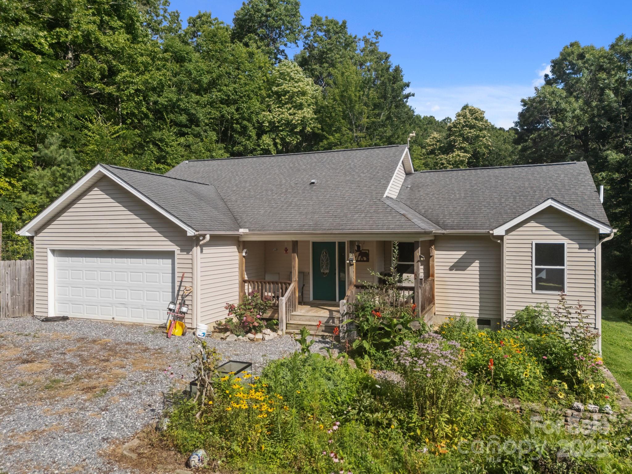 55 Pine Bluff Road Hendersonville, NC 28792 - Photo 43 of 47 a front view of house with yard and trees in the background
