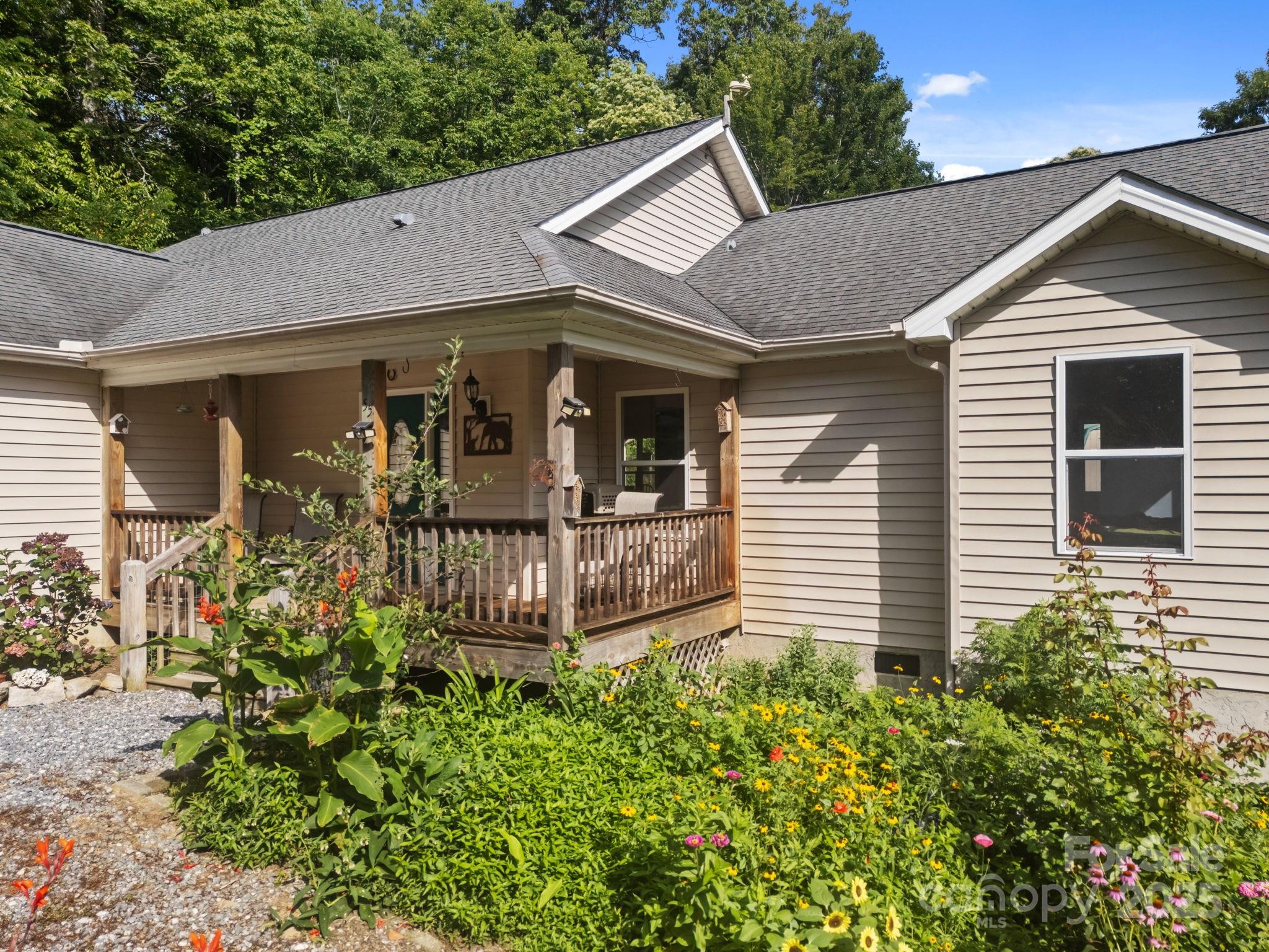 55 Pine Bluff Road Hendersonville, NC 28792 - Photo 44 of 47 a view of a house with brick walls and a flower garden