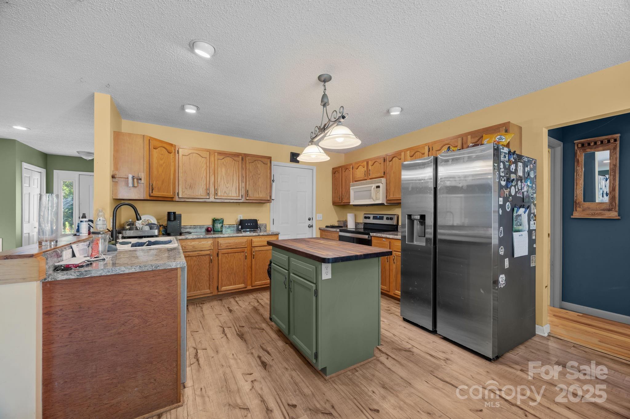 55 Pine Bluff Road Hendersonville, NC 28792 - Photo 7 of 47 a kitchen with refrigerator and cabinets