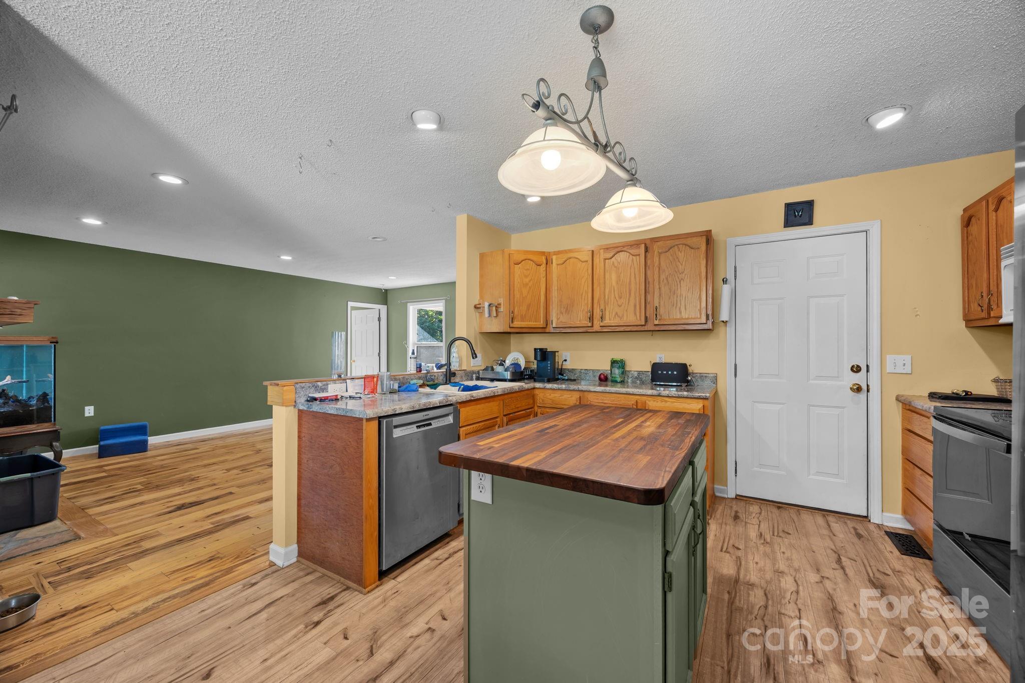 55 Pine Bluff Road Hendersonville, NC 28792 - Photo 8 of 47 a kitchen with stainless steel appliances granite countertop a sink a stove and a refrigerator
