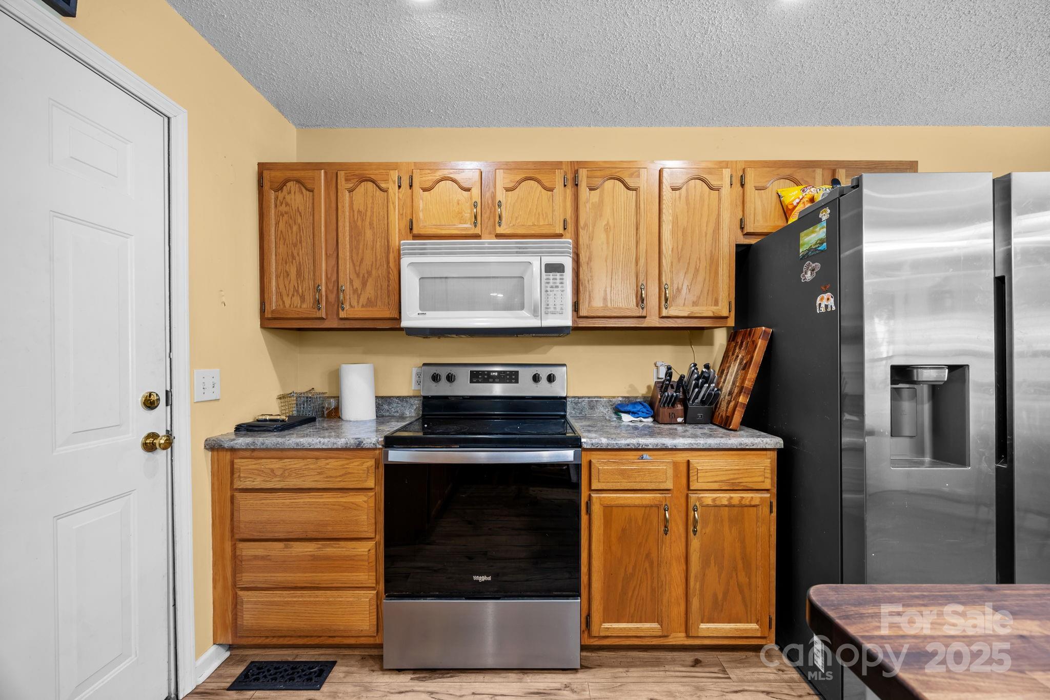 55 Pine Bluff Road Hendersonville, NC 28792 - Photo 10 of 47 a kitchen with stainless steel appliances granite countertop a stove and a refrigerator
