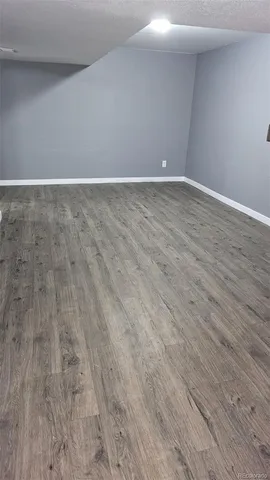 a view of an empty room and wooden floor