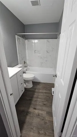 a bathroom with a sink a toilet and a shower