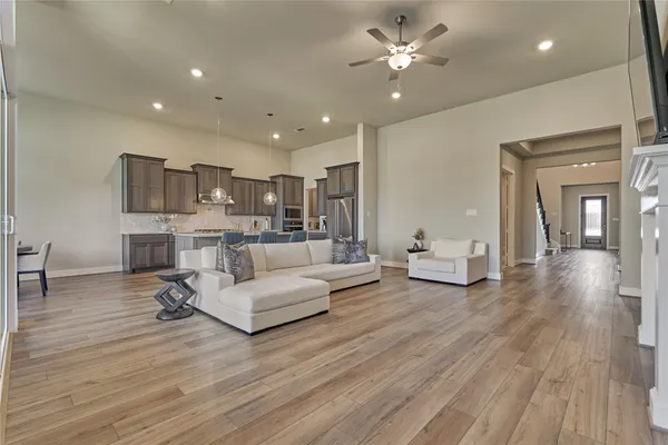 a living room with furniture and a wooden floor