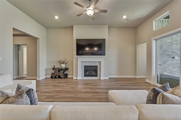 a living room with furniture a fireplace and a flat screen tv