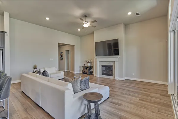 a living room with furniture a fireplace and a flat screen tv