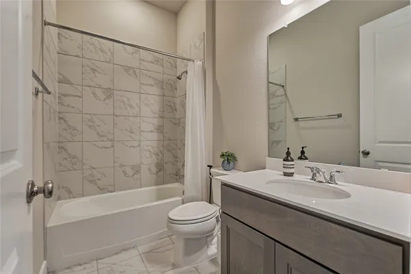a bathroom with a sink a toilet and bathtub