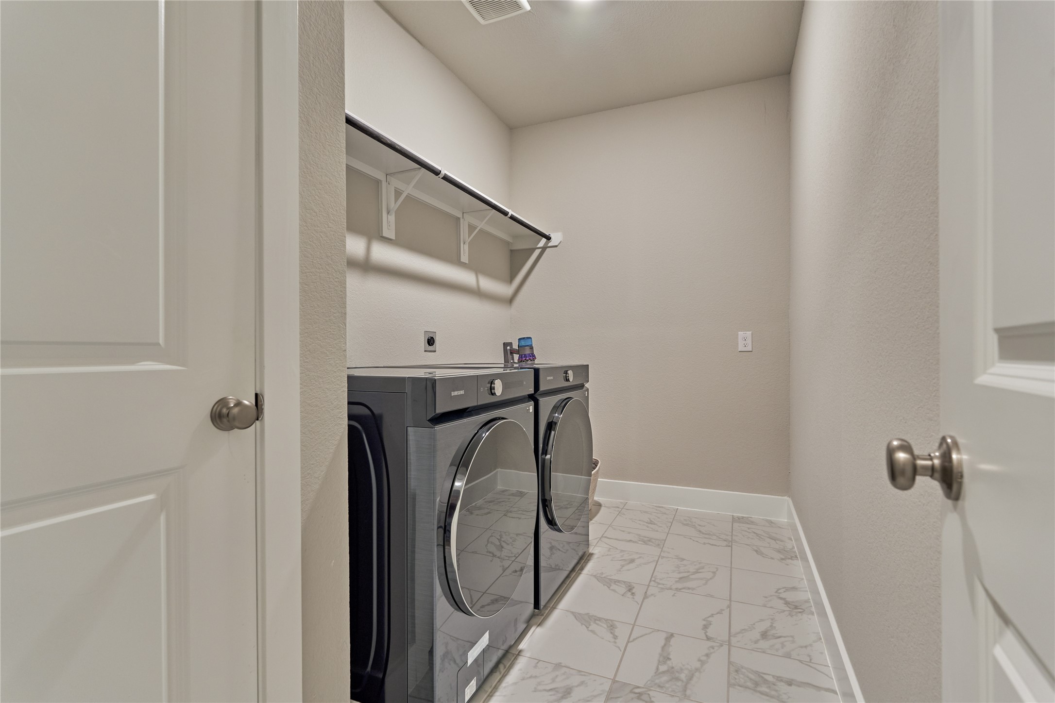 1716 Encino Boulevard Conroe, TX 77304 - Photo 35 of 50 Laundry room with storage closet, shelf for storage and hanging clothes rod.