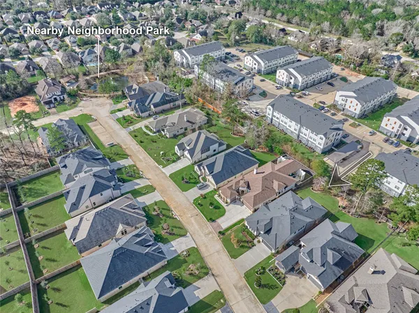 an aerial view of residential houses with outdoor space