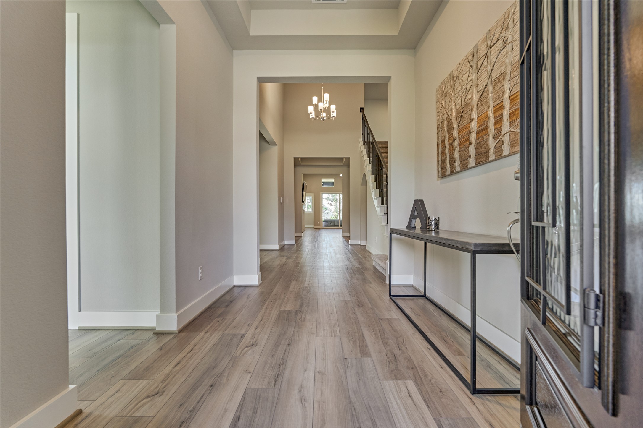 1716 Encino Boulevard Conroe, TX 77304 - Photo 6 of 50 Upon entering you will notice the soaring 12 ft ceilings and wood-look tile flooring throughout.