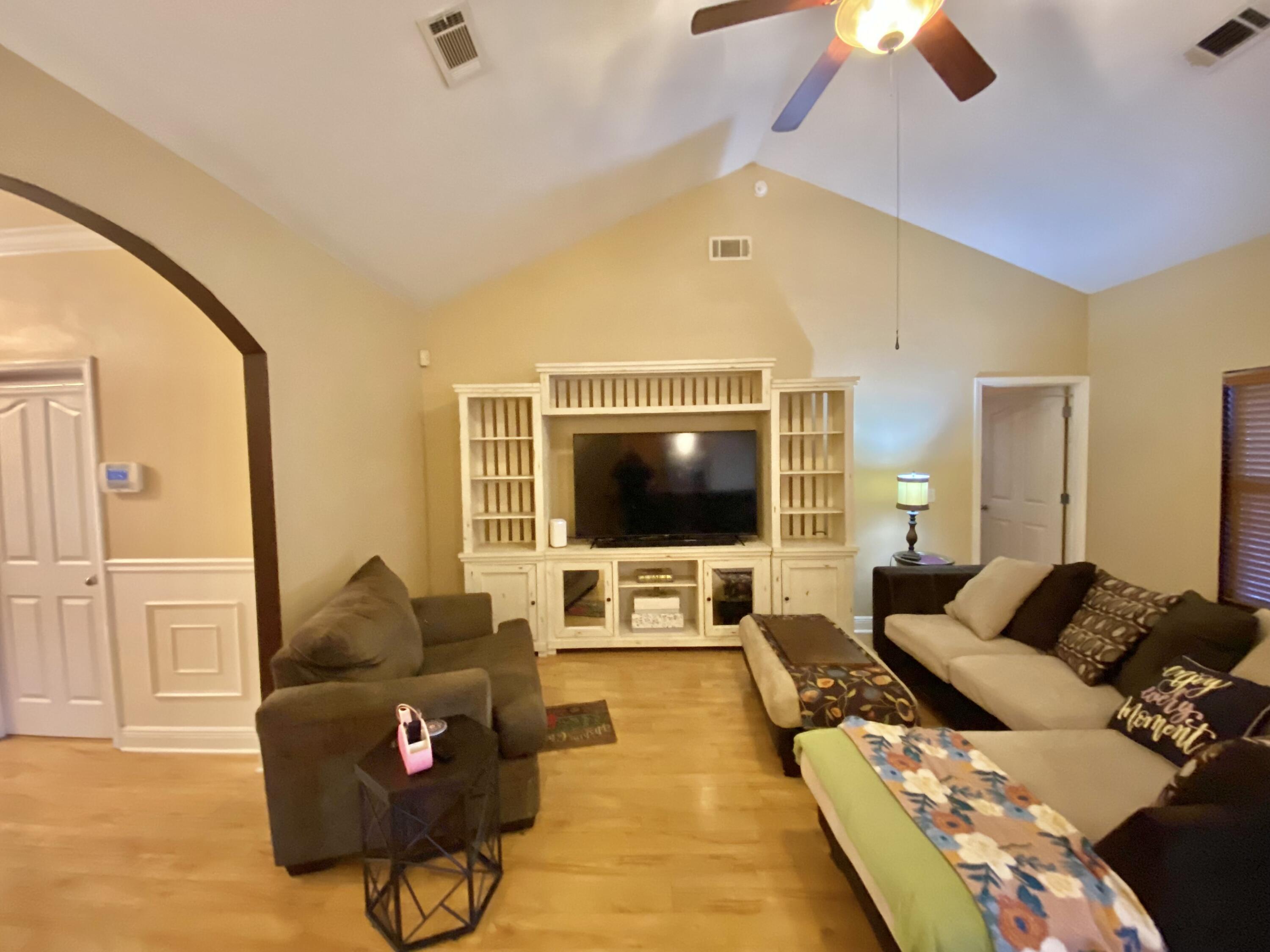 402 Wych Circle Crestview, FL 32536 - Photo 16 of 48 a living room with furniture and a flat screen tv