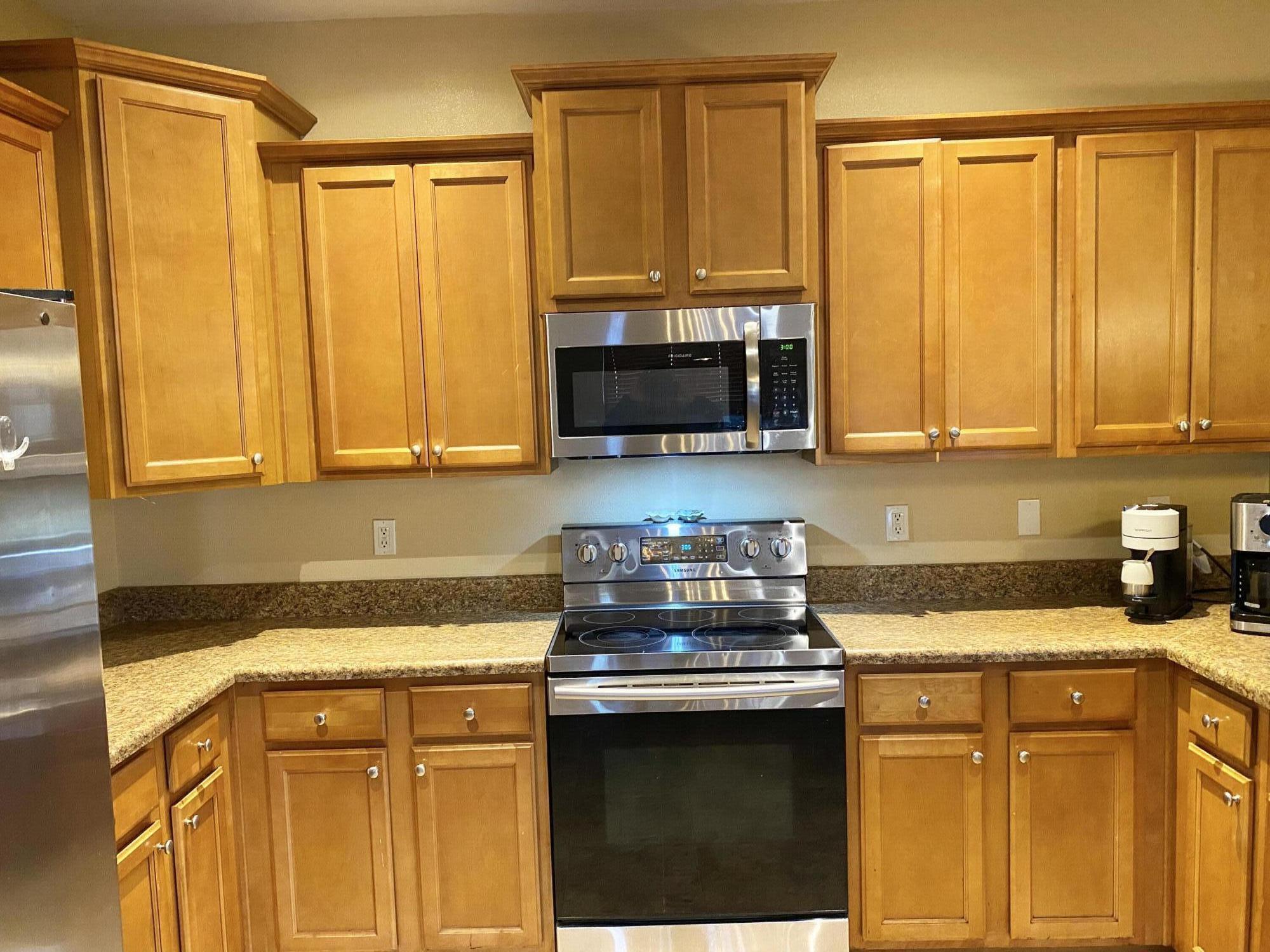 402 Wych Circle Crestview, FL 32536 - Photo 26 of 48 a kitchen with a stove a sink and a microwave