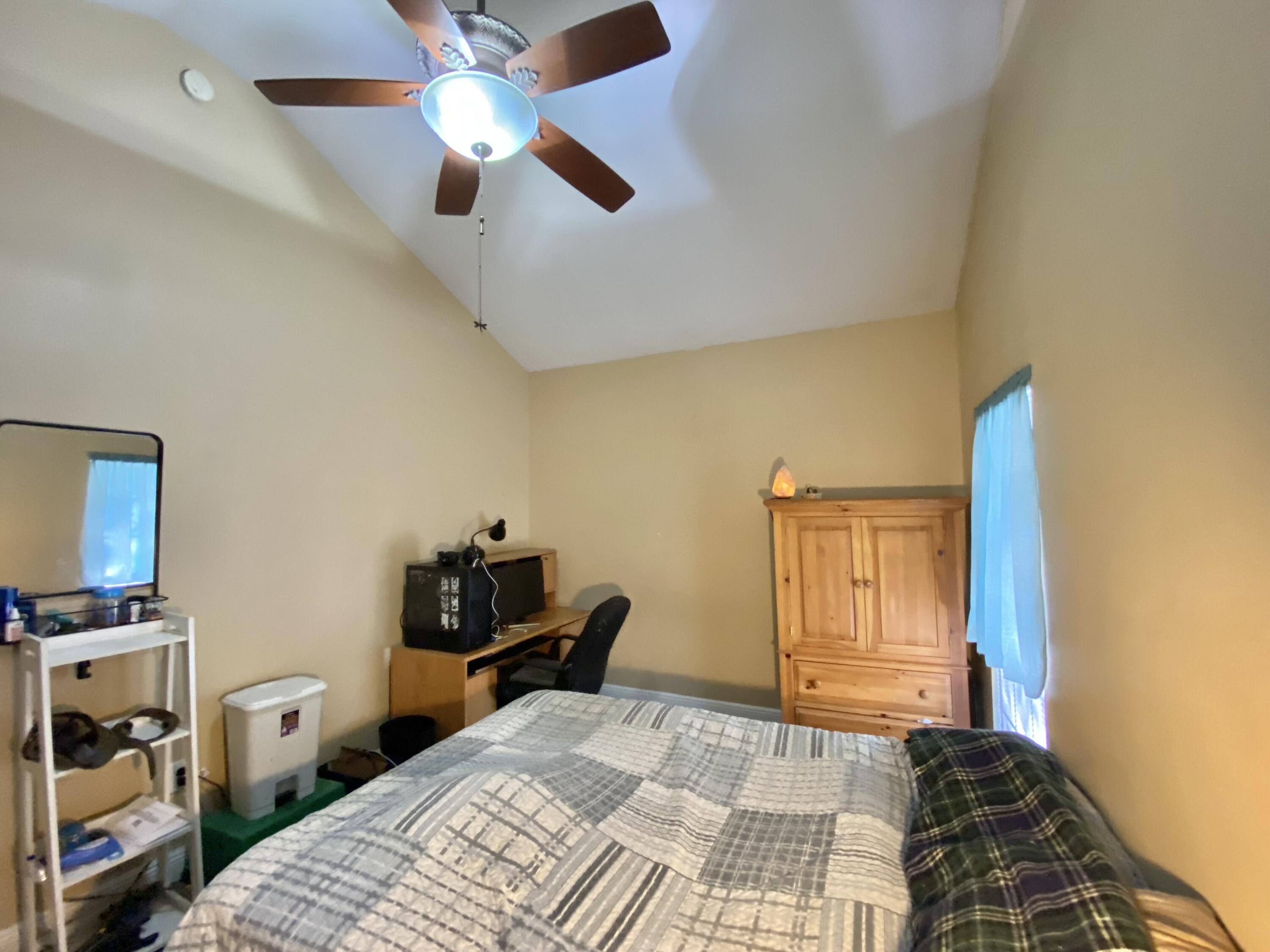 402 Wych Circle Crestview, FL 32536 - Photo 36 of 48 a bedroom with a bed and a chandelier