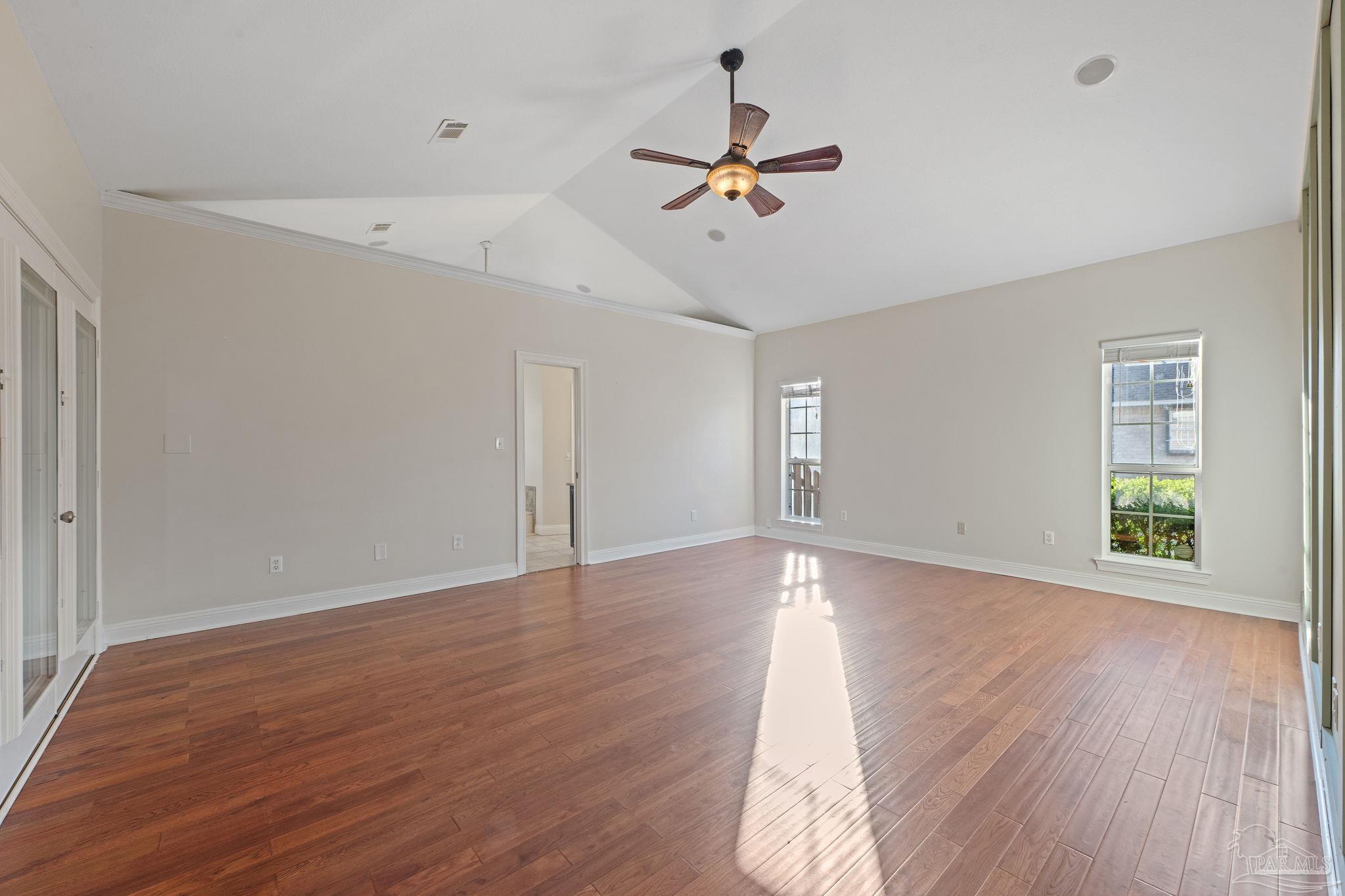 4149 Chartwell Street Pace, FL 32571 - Photo 19 of 49 a view of a room with wooden floor and ceiling fan