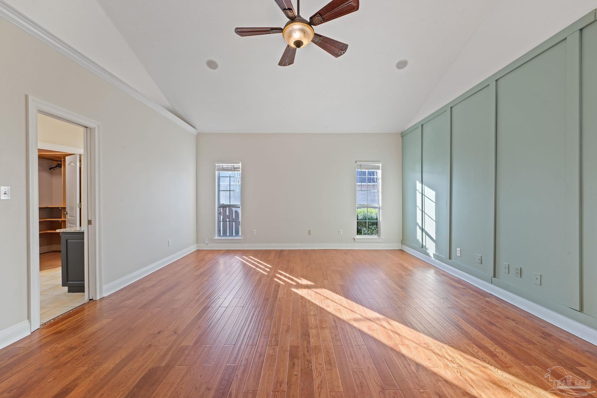 4149 Chartwell Street Pace, FL 32571 - Photo 21 of 49 a view of empty room with wooden floor and fan