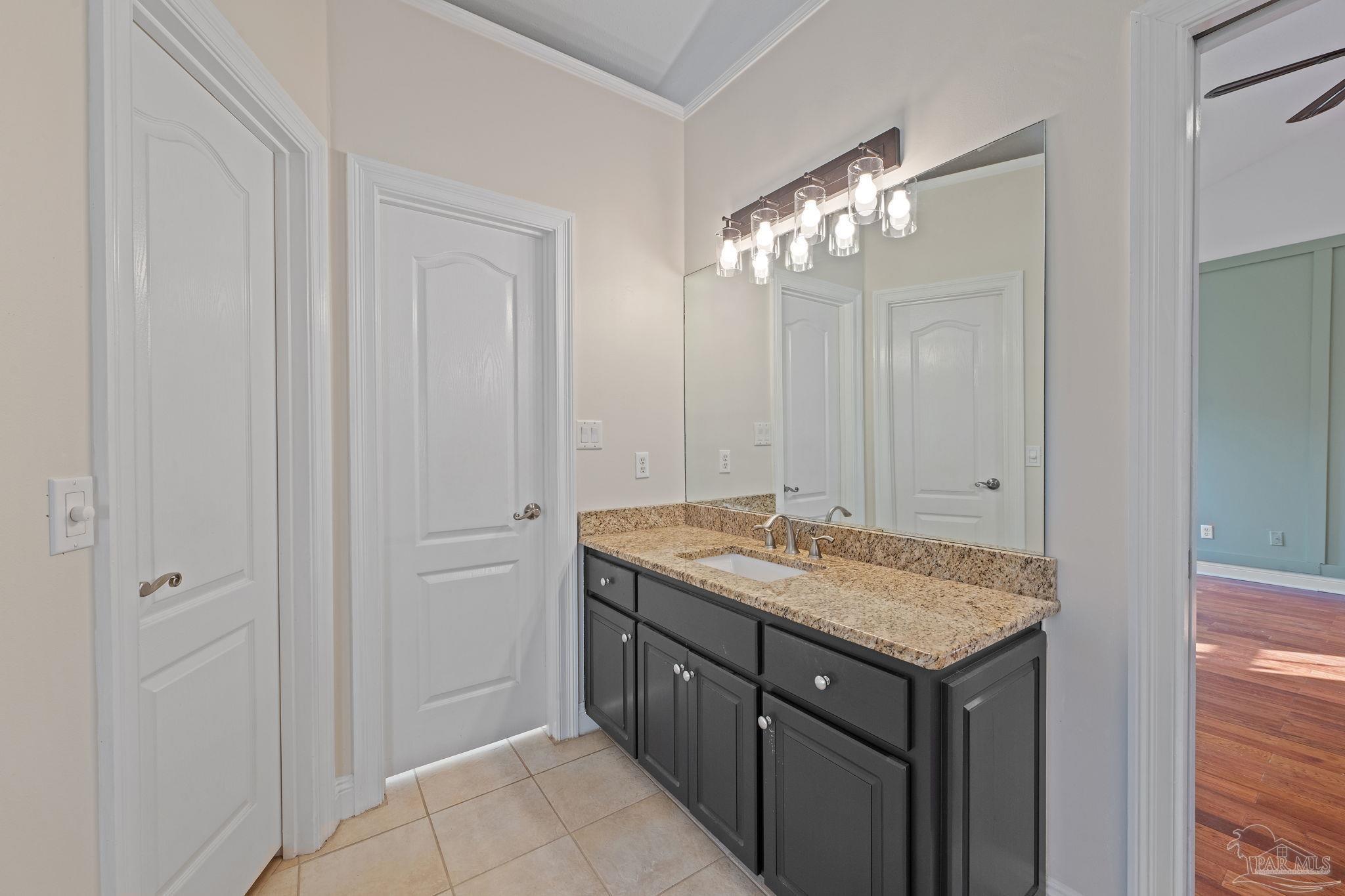 4149 Chartwell Street Pace, FL 32571 - Photo 22 of 49 a bathroom with a granite countertop sink and a mirror