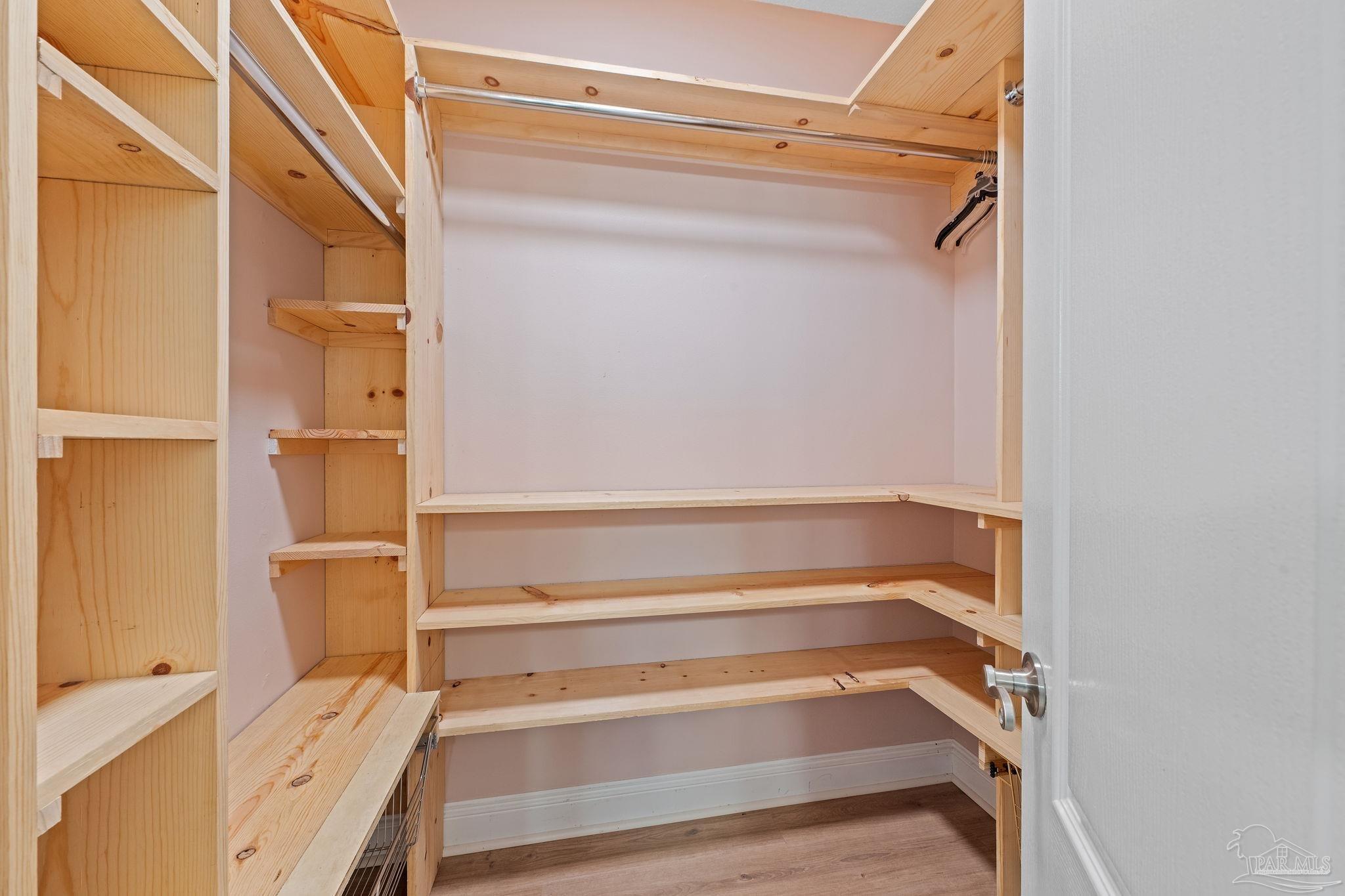 4149 Chartwell Street Pace, FL 32571 - Photo 27 of 49 a view of walk in closet with empty racks